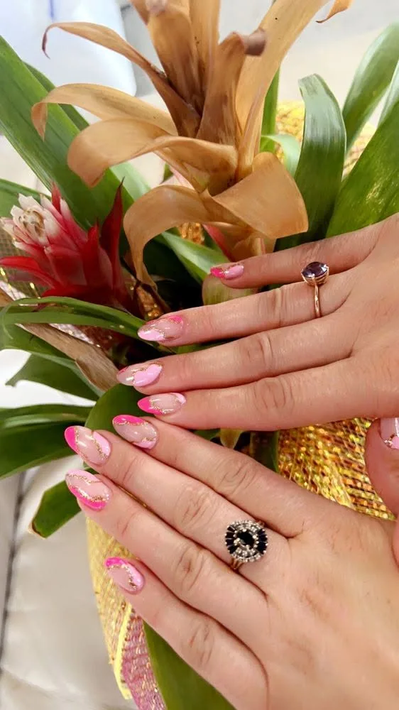 Soft-pink almond nails with delicate gold-leaf marble detailing.