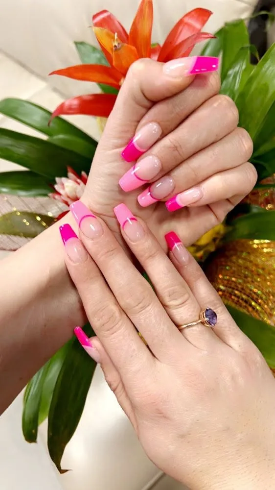 Long nails with vivid pink French tips.